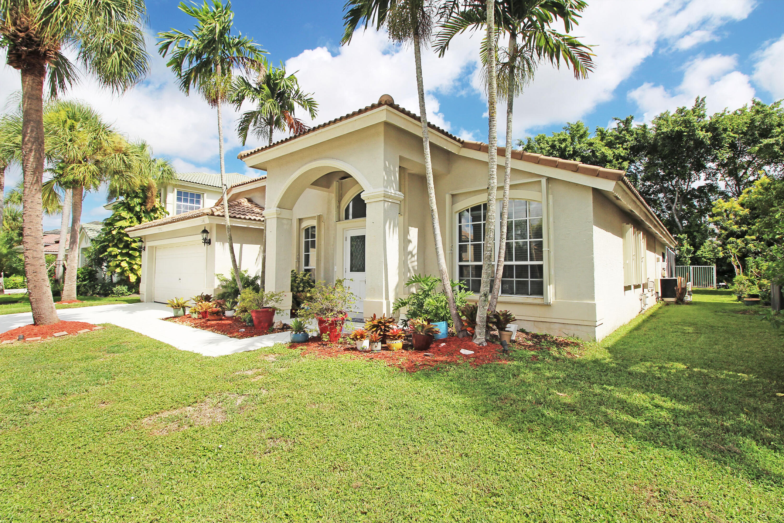 a front view of house with yard and green space