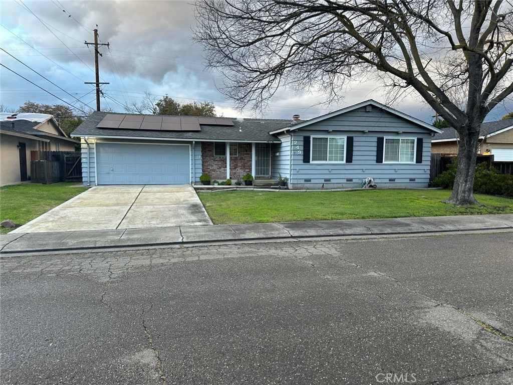 a front view of house with yard and green space