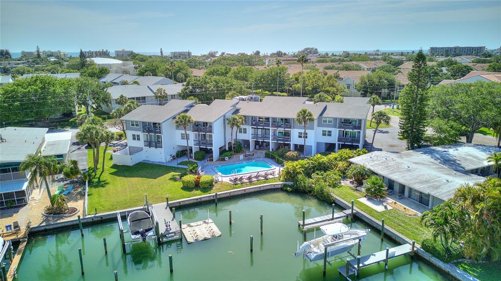 an aerial view of a house with swimming pool outdoor seating and yard