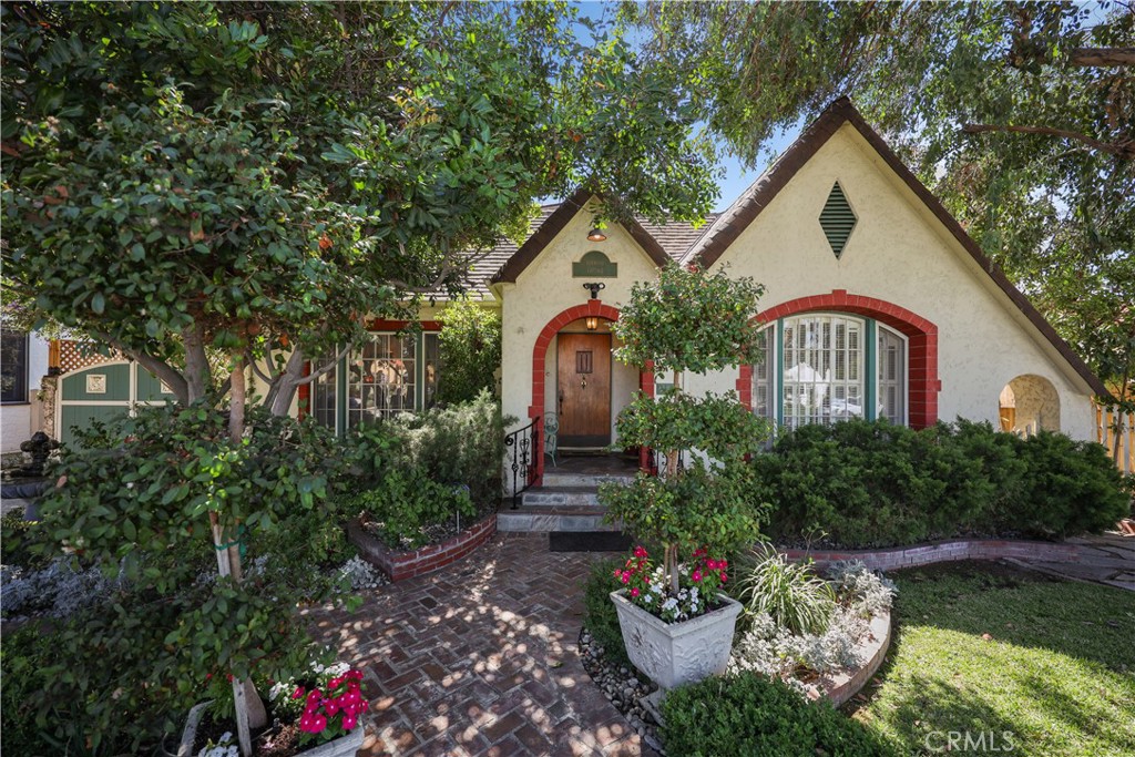 ‘Boxwood Cottage’  A one level, 1929 Tudor on Heliotrope Drive with curb appeal galore.