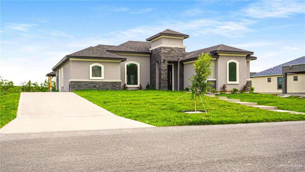 a front view of a house with a yard and garage