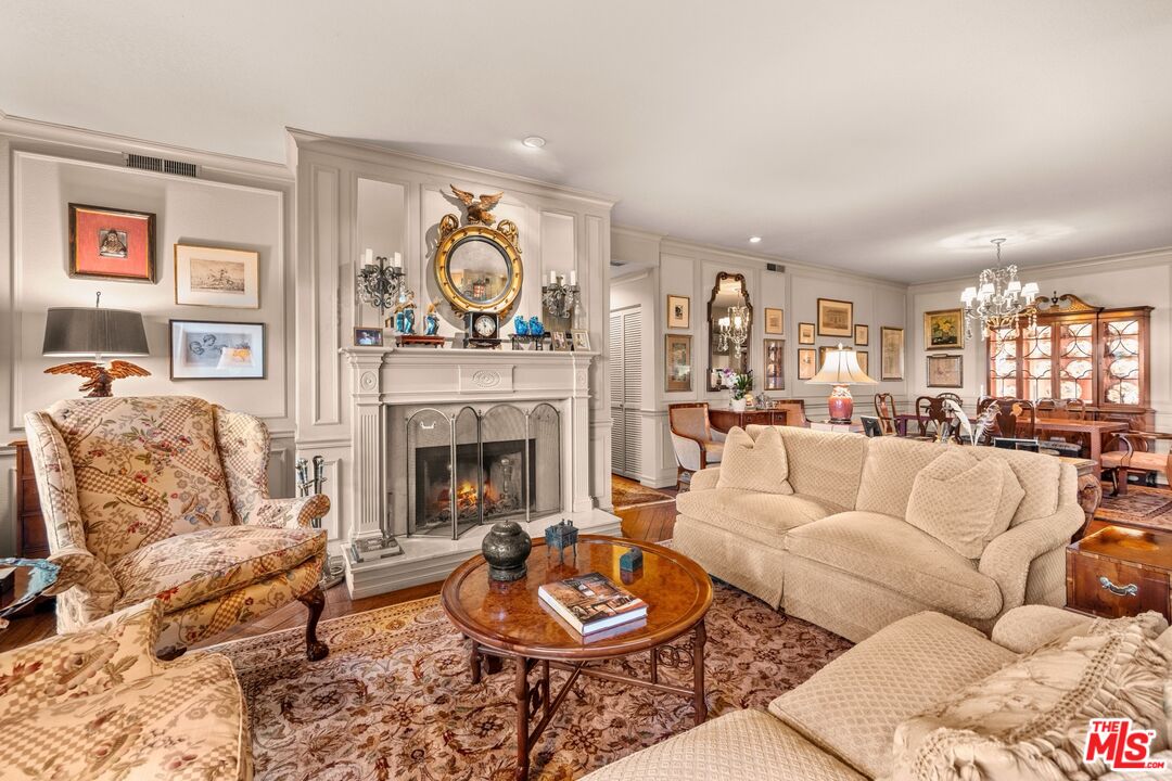 a living room with furniture a rug and a fireplace