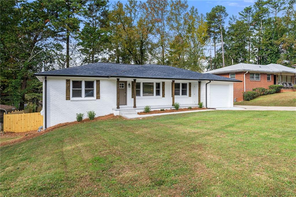 a front view of a house with yard patio and green space