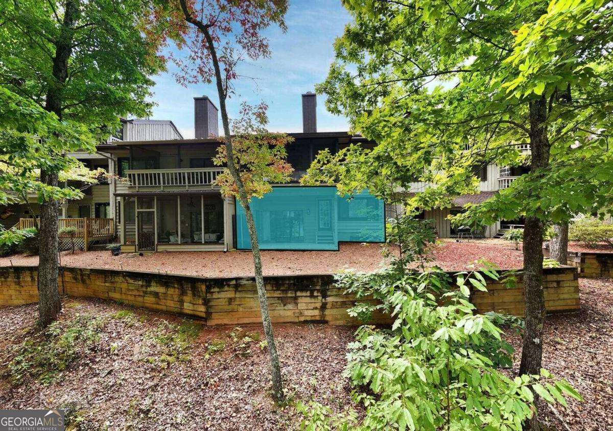 a front view of a house with a yard and fountain in middle of the lake