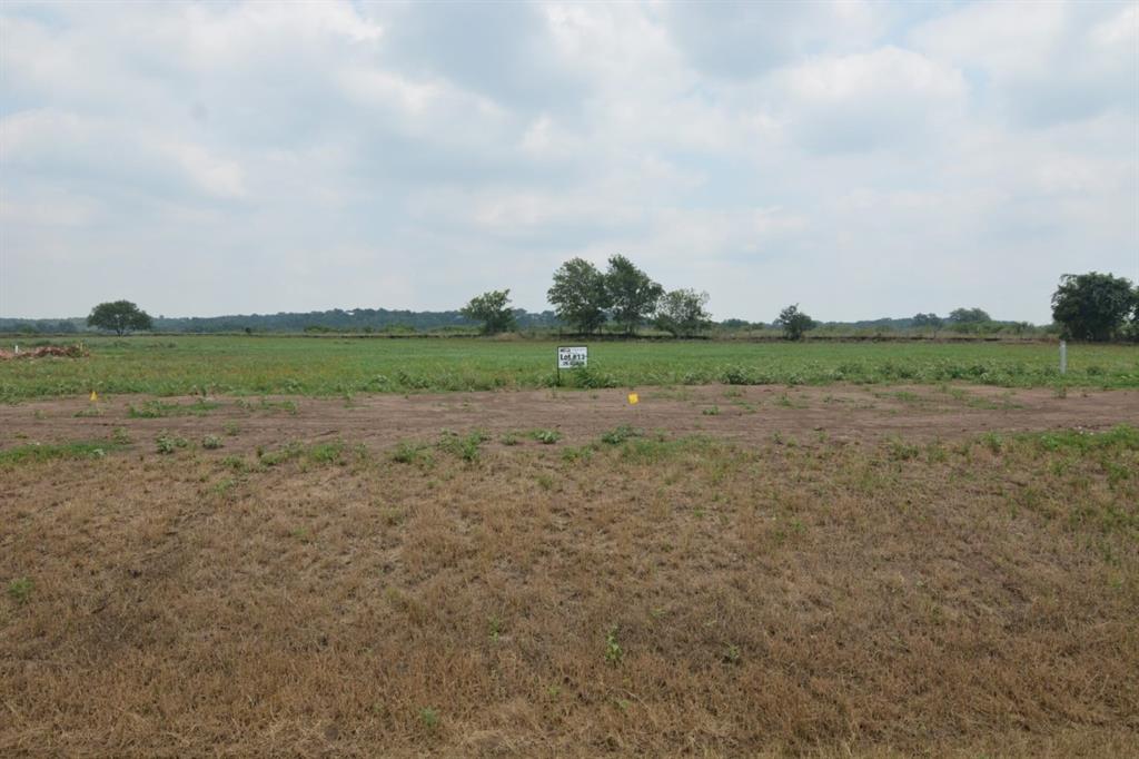 a view of a field with wooden fence