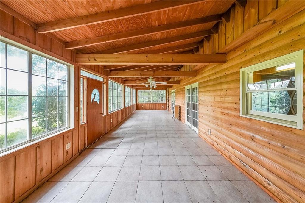 a view of a porch with wooden floor and windows