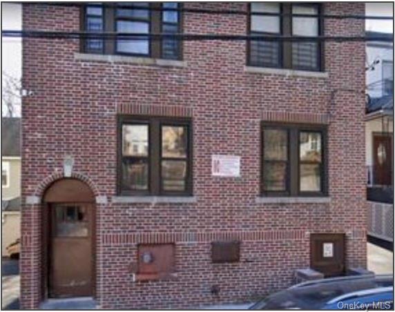 a front view of a brick building with windows