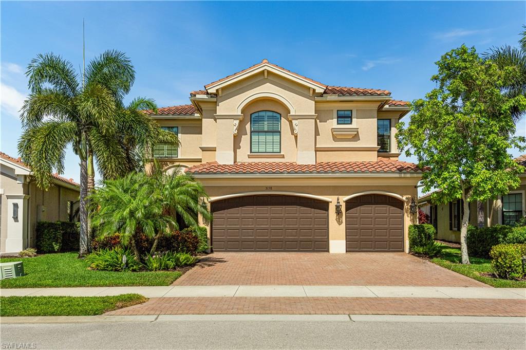 a front view of a house with a yard and garage