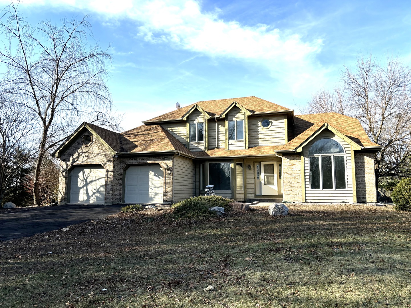 a front view of a house with a garden