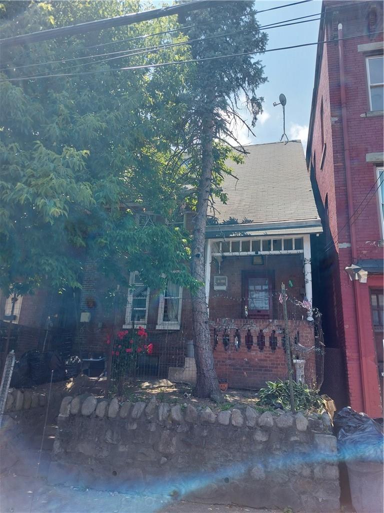 Terrace and stoop elevated above sidewalk offering a private space to sit.