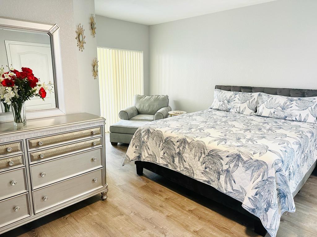 a bedroom with a bed and a potted plant