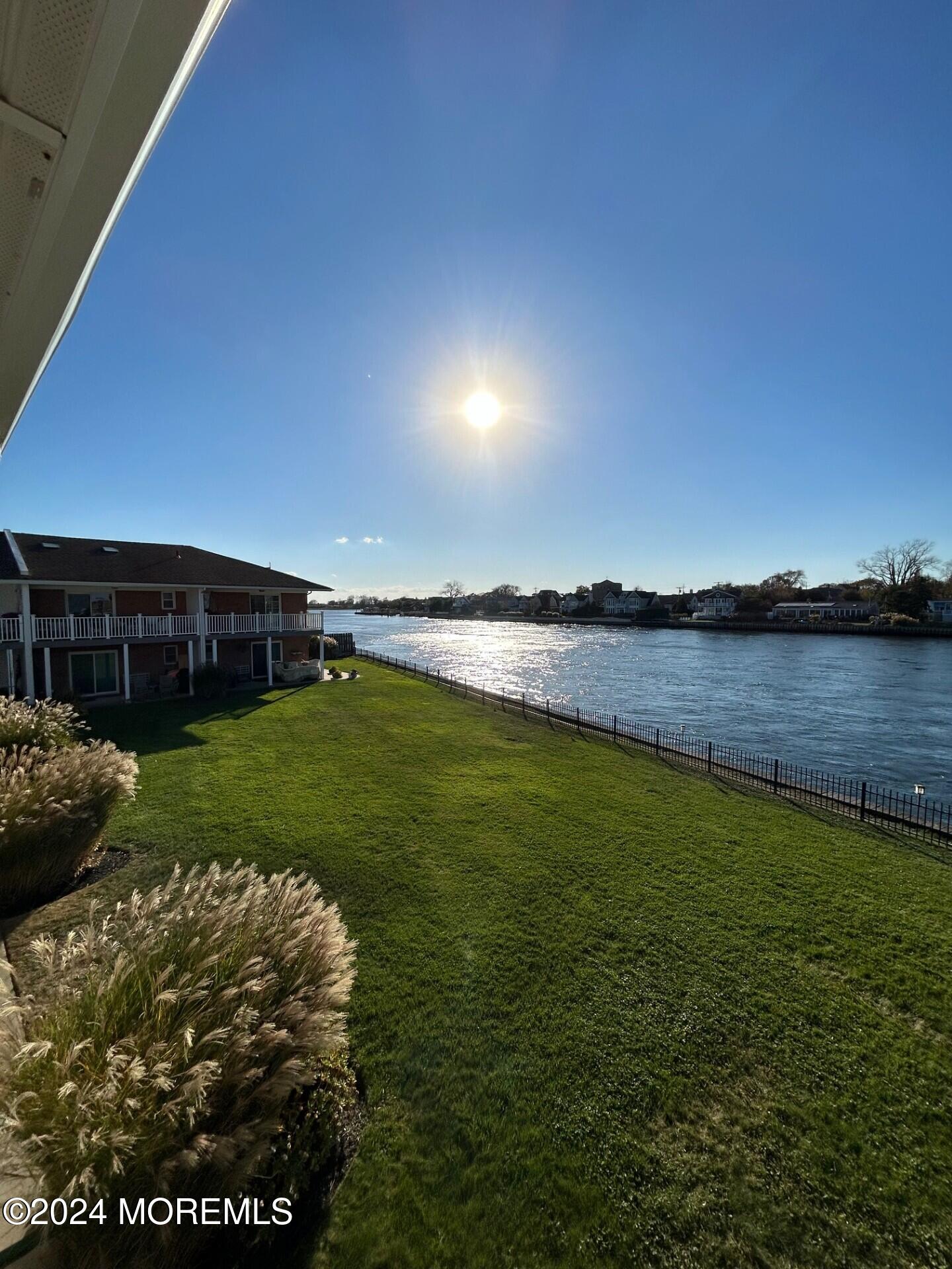 a view of a lake with houses in the background