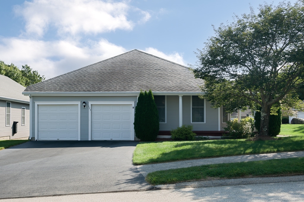 a front view of a house with a garden