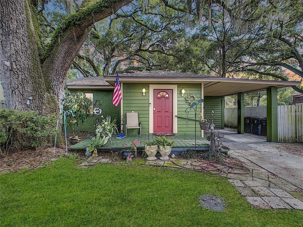 a front view of house with yard and outdoor seating