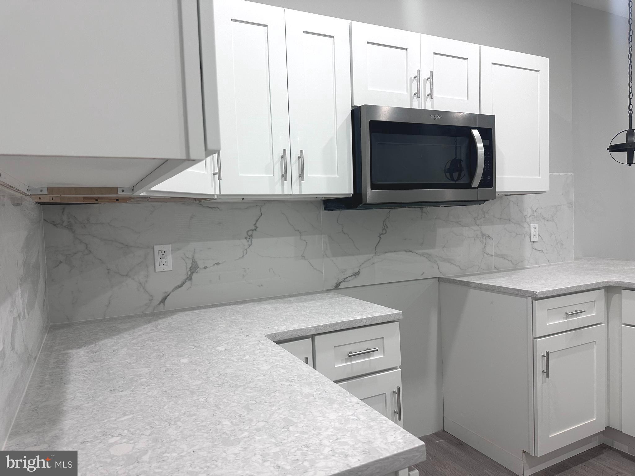 a kitchen with stainless steel appliances a stove microwave and sink