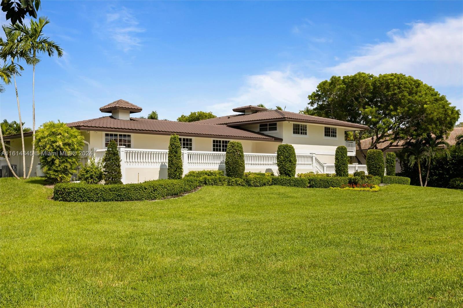 a front view of a house with a garden