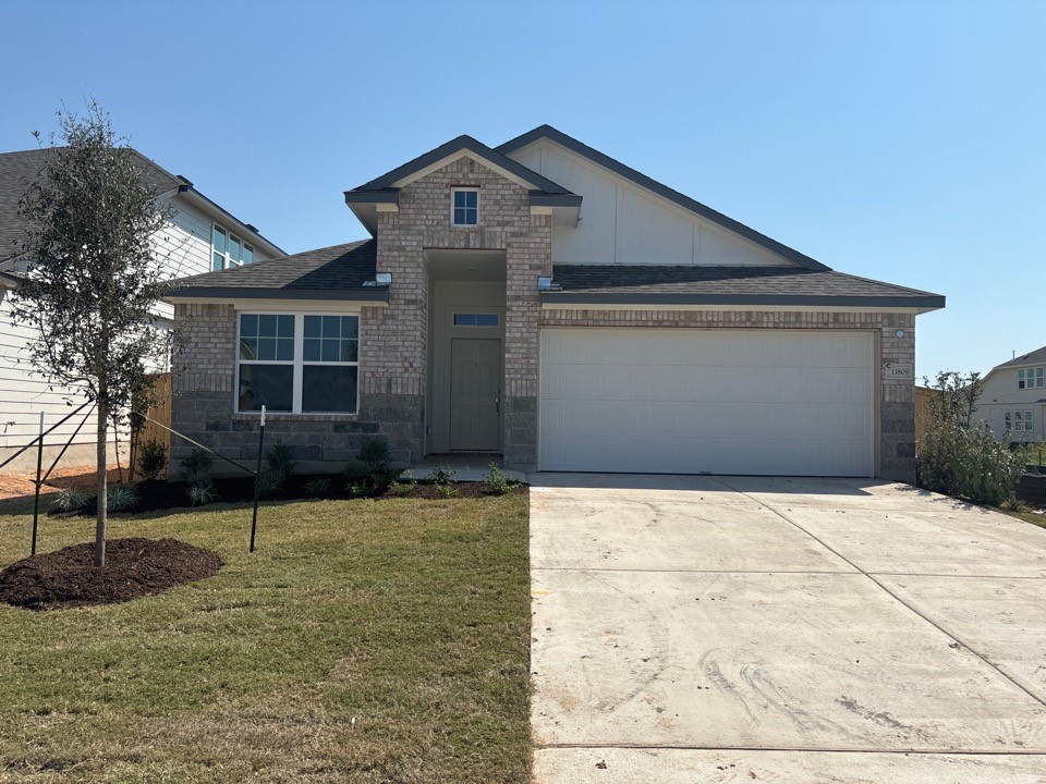 a front view of a house with a yard