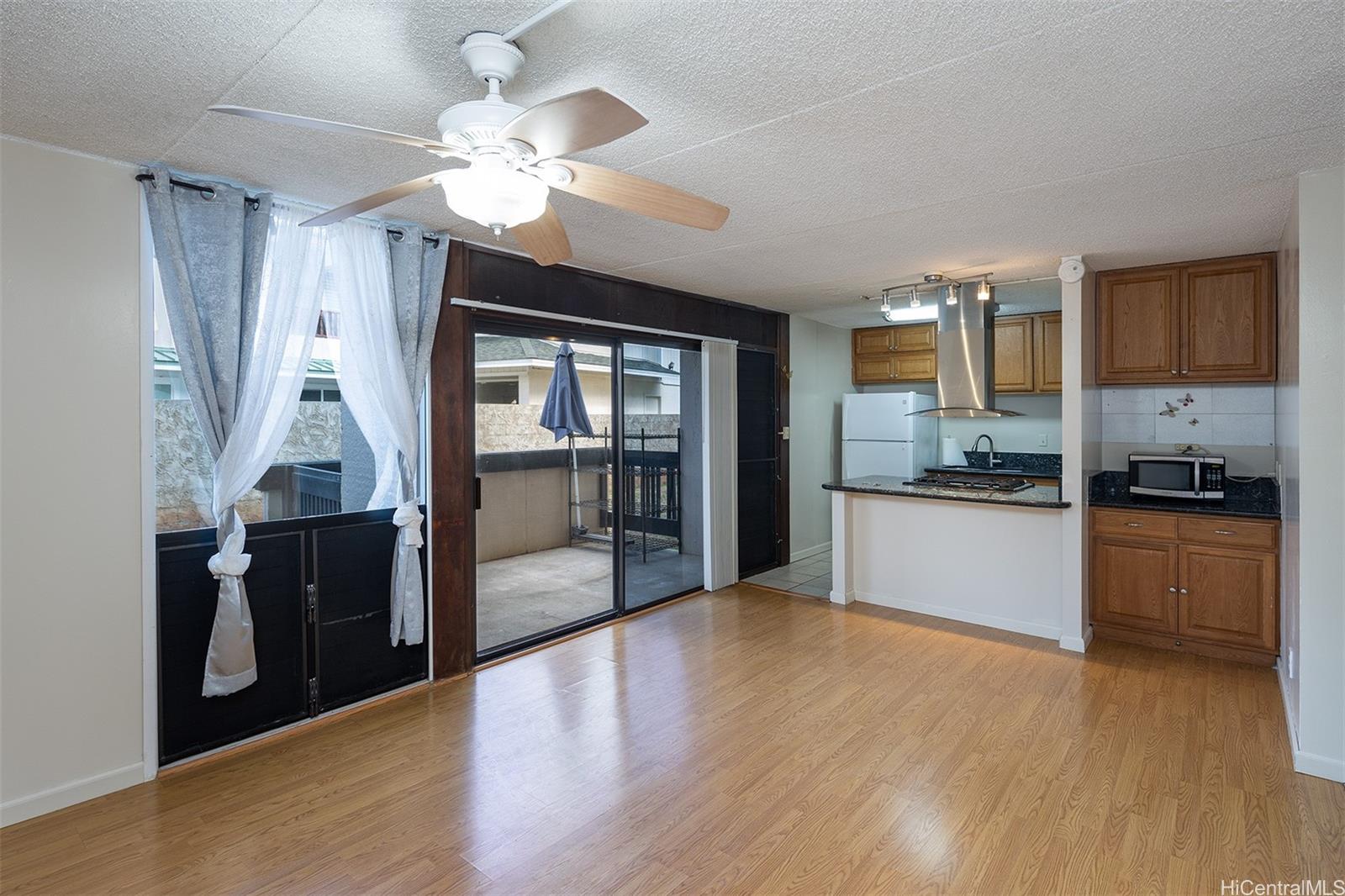 a large kitchen with cabinets wooden floor and stainless steel appliances