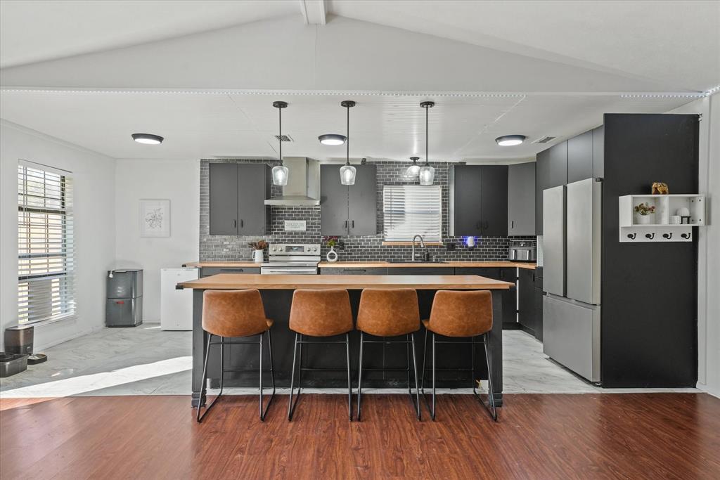 a large kitchen with lots of counter space and wooden floor