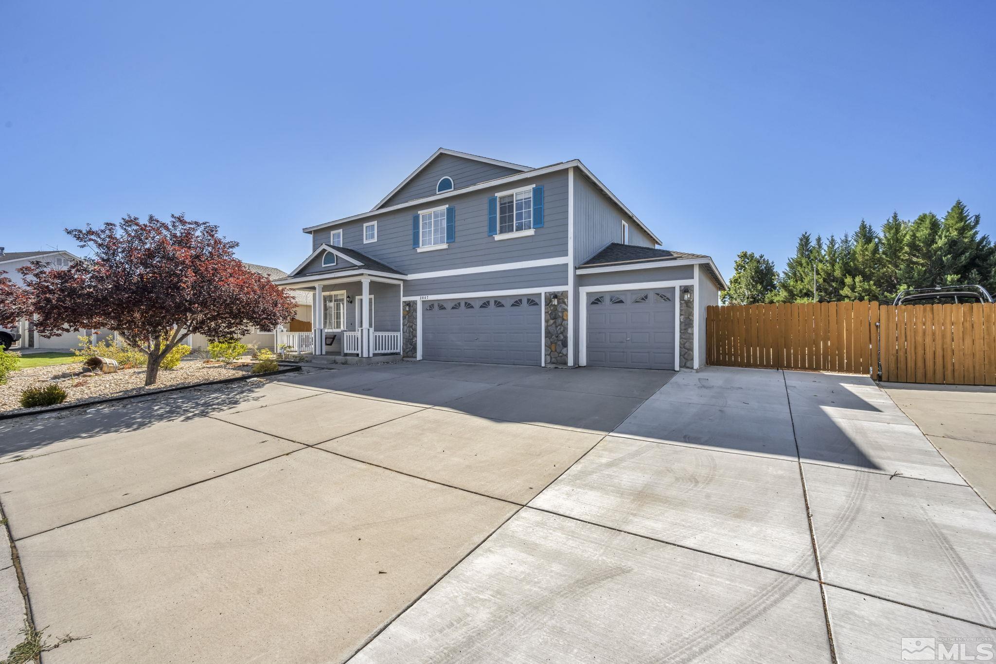 a front view of a house with a yard and a garage