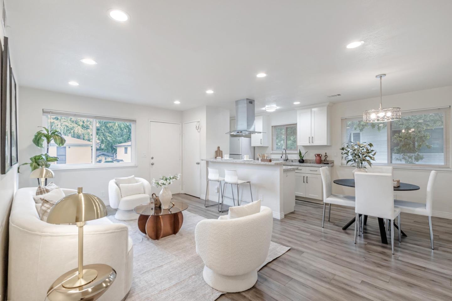 a living room with kitchen island furniture and a wooden floor