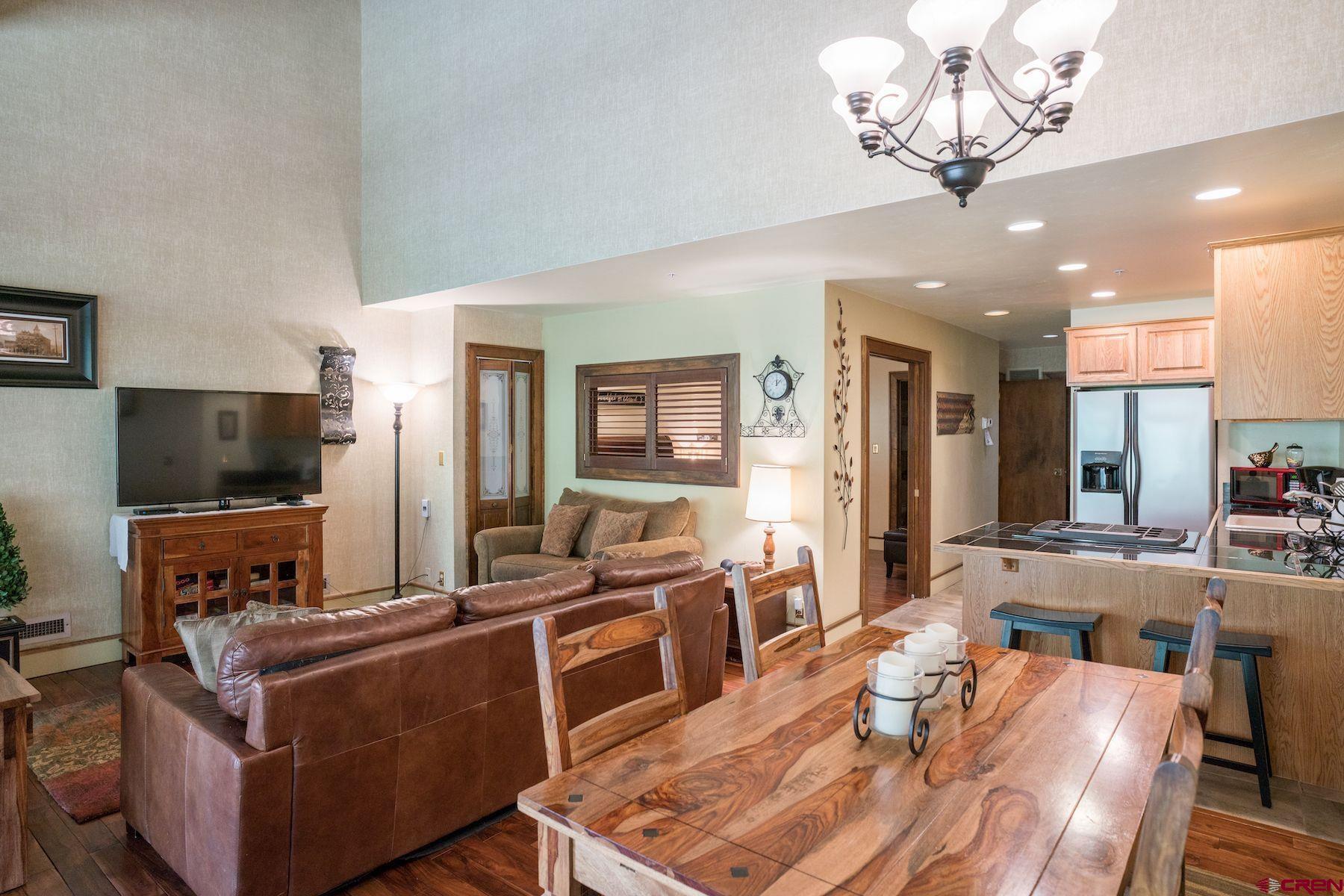 a living room with fireplace furniture and a flat screen tv