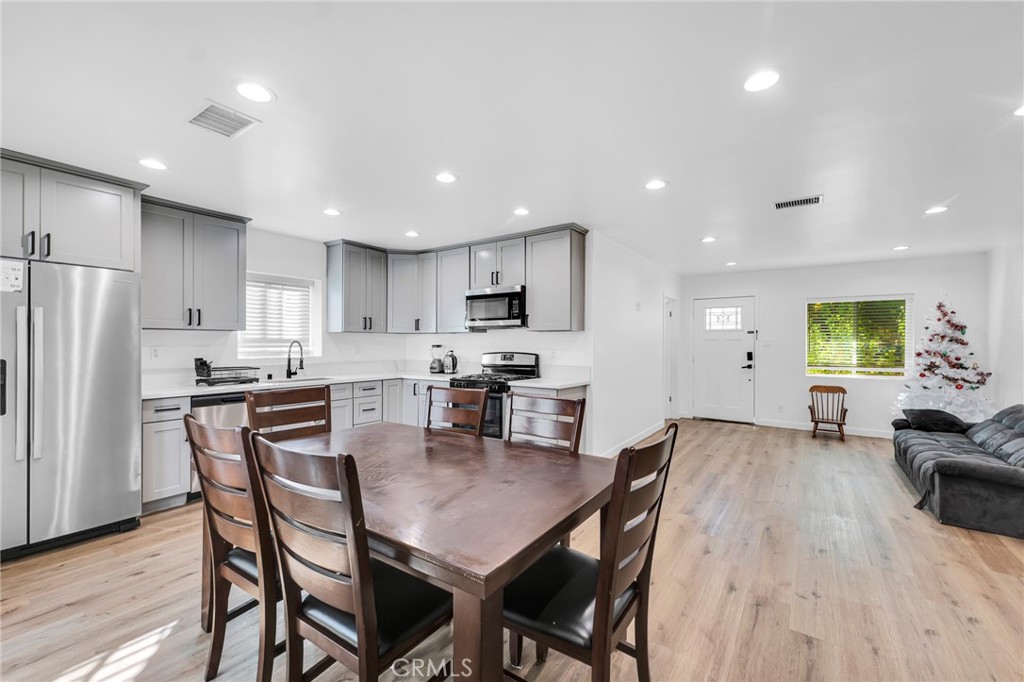 a view of kitchen with cabinets table and chairs