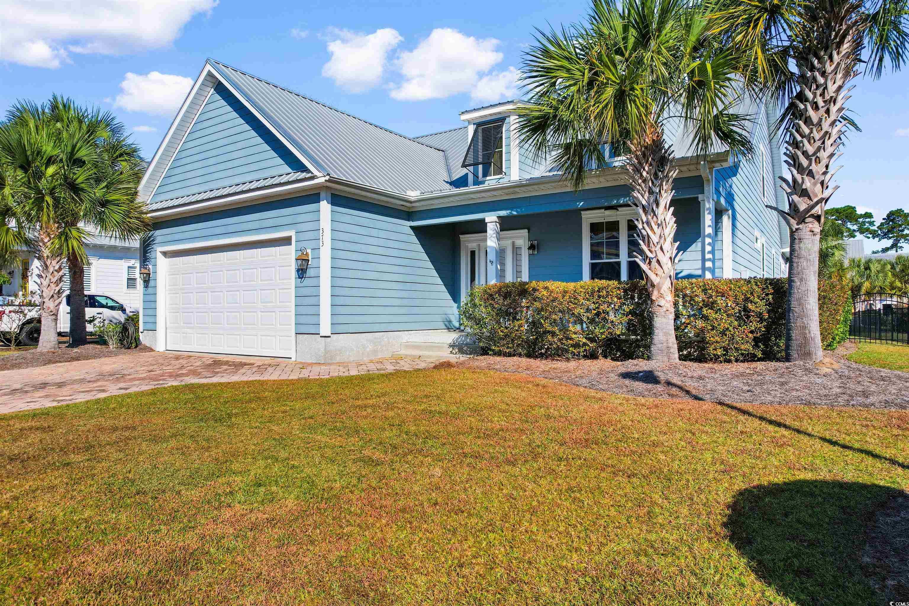 View of front of property featuring a garage, a fr