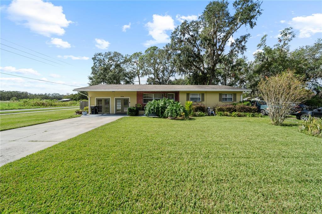 a front view of house with yard and green space