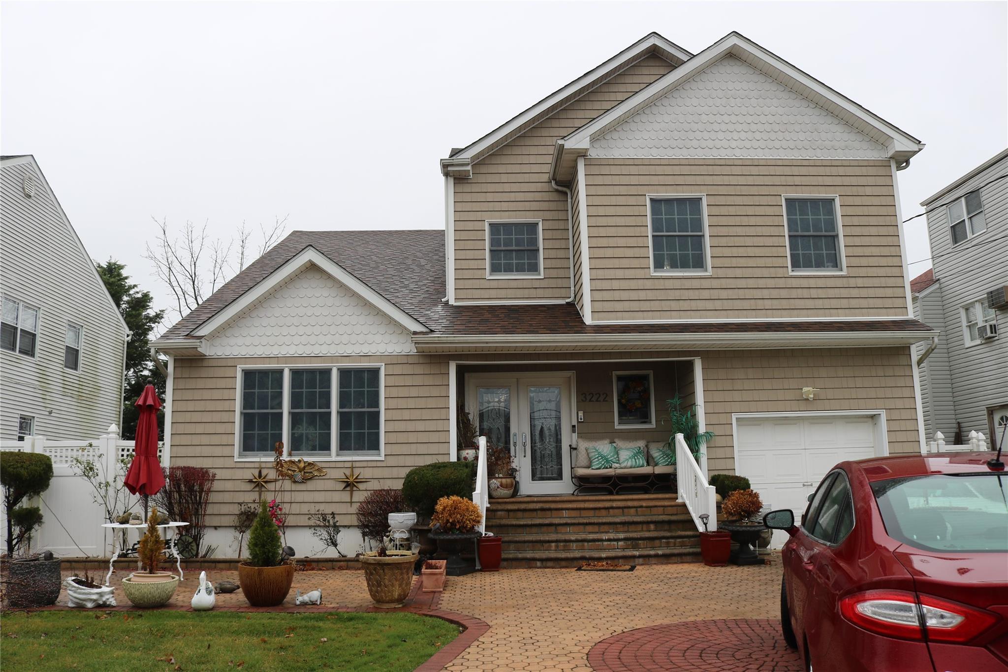 View of front of home with a porch and a garage