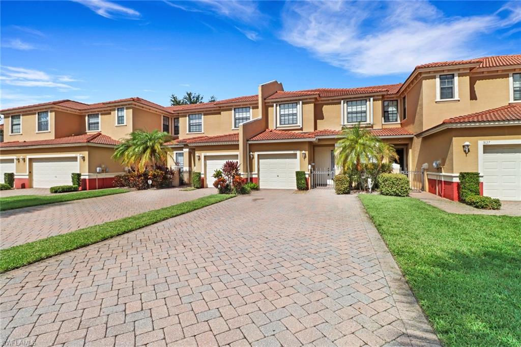 View of front of house featuring a garage and a front lawn