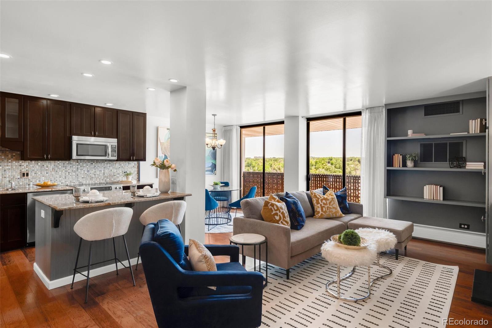 a living room with furniture a rug and a large window