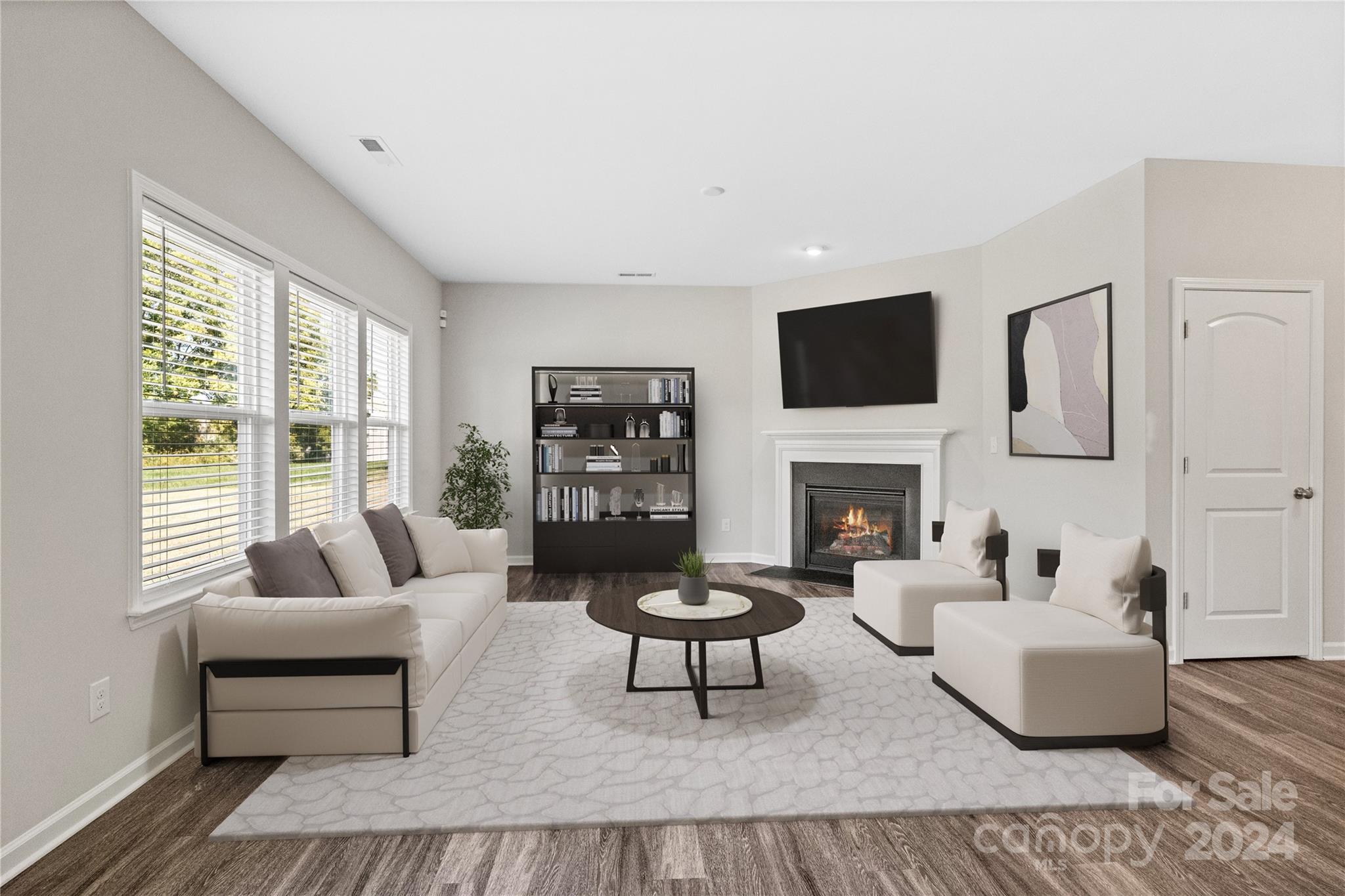 a living room with furniture a fireplace and a flat screen tv