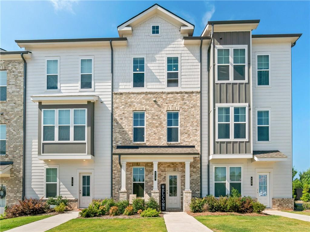 a front view of a residential apartment building with a yard