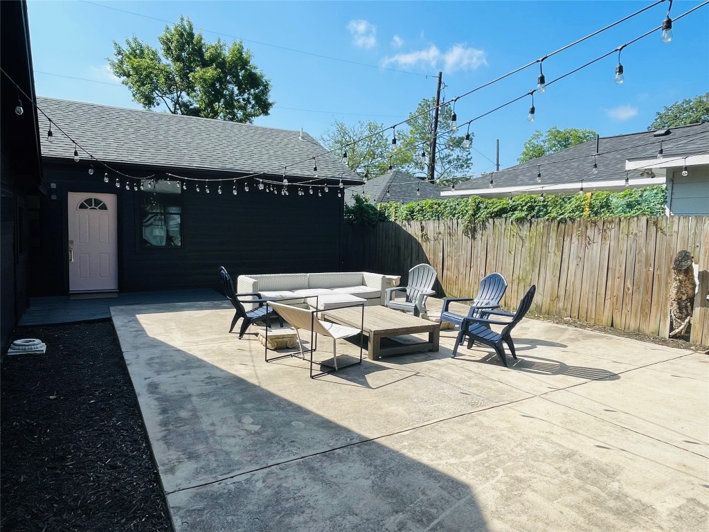 a roof deck with table and chairs under an umbrella