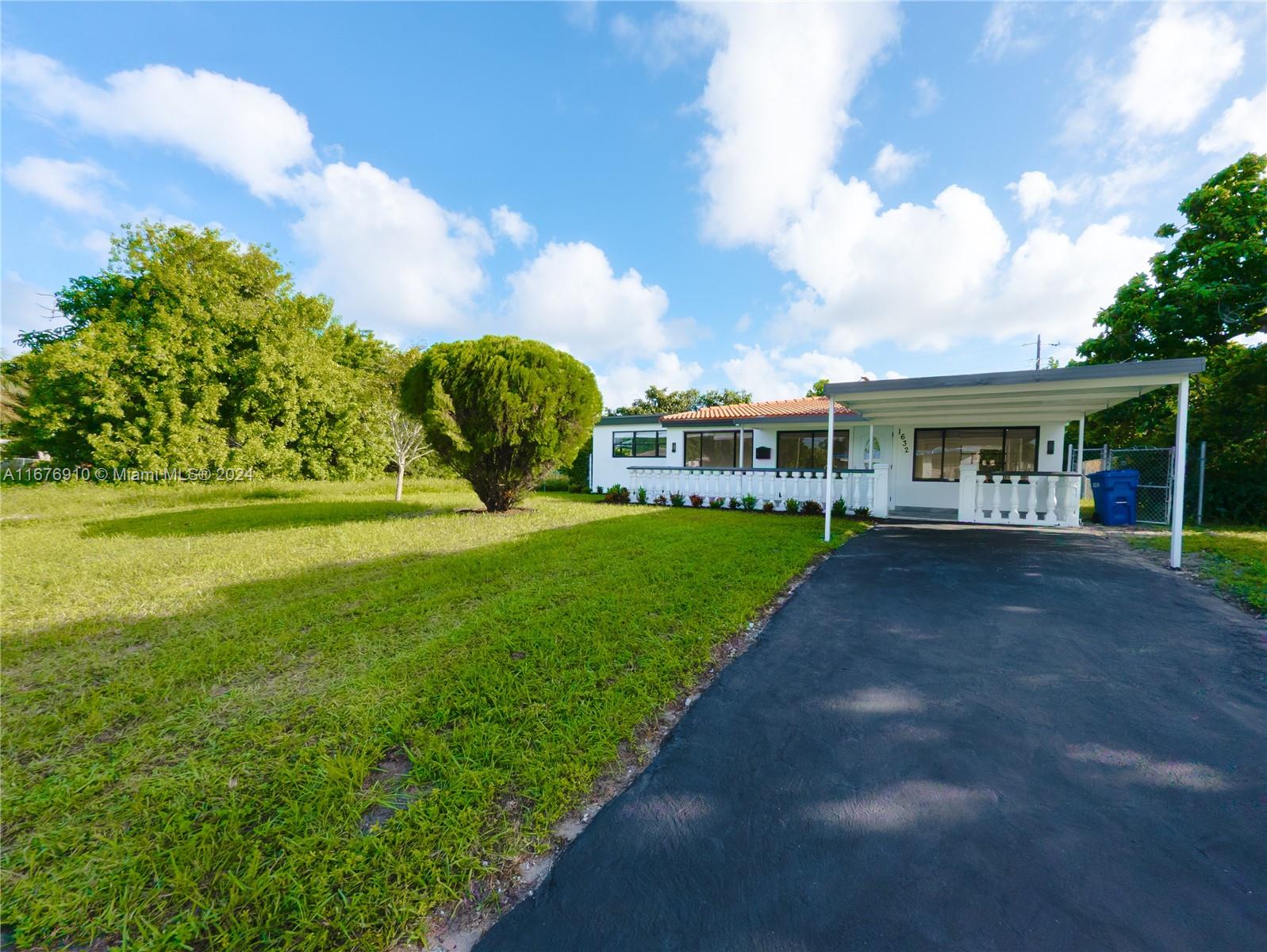 a view of house with yard and green space