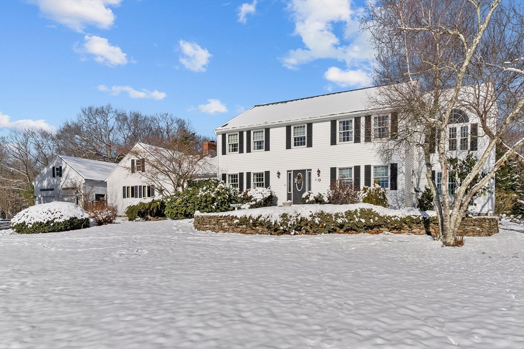 a view of white house with a yard