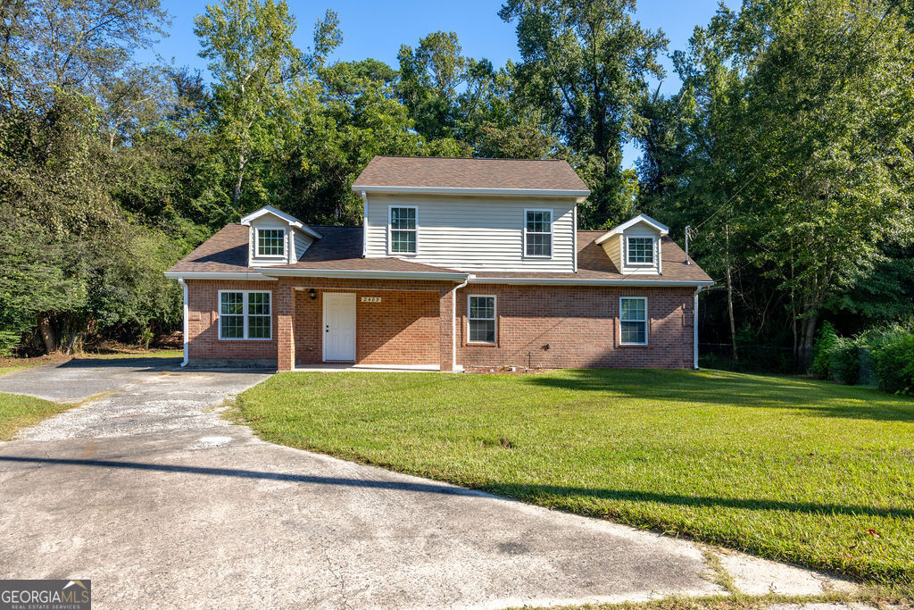 a front view of a house with a garden