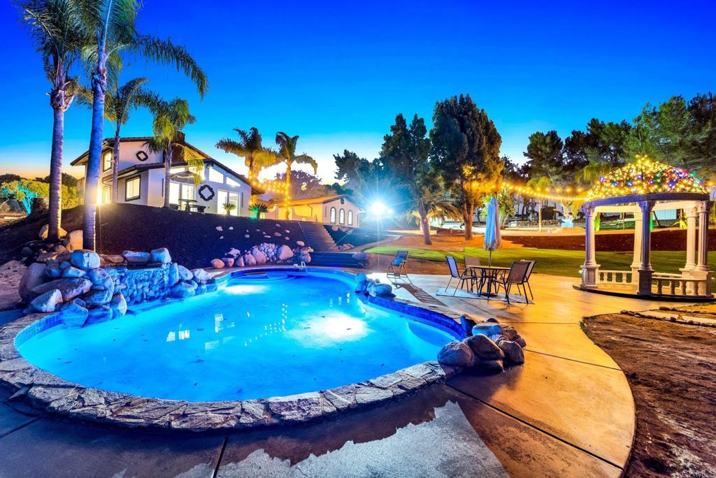 a view of a swimming pool with an outdoor space and seating area