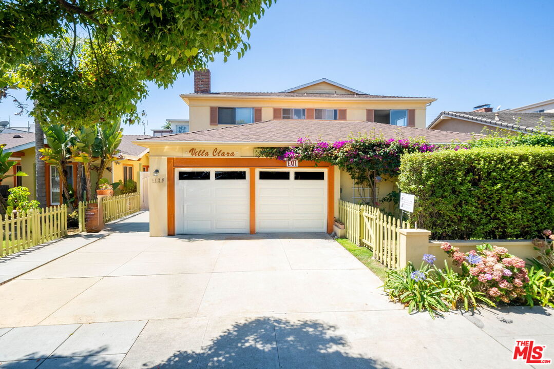 a front view of a house with a porch and a garage