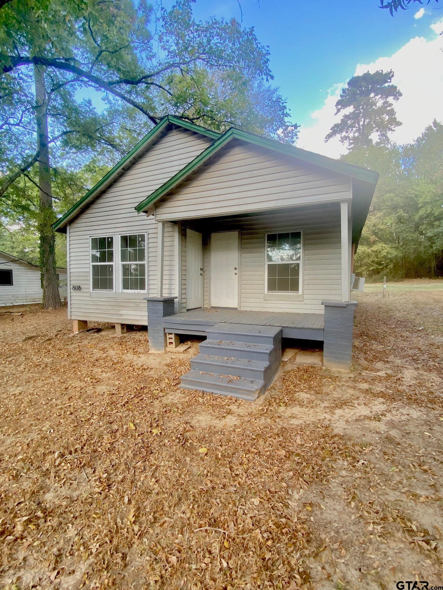 a front view of a house with yard