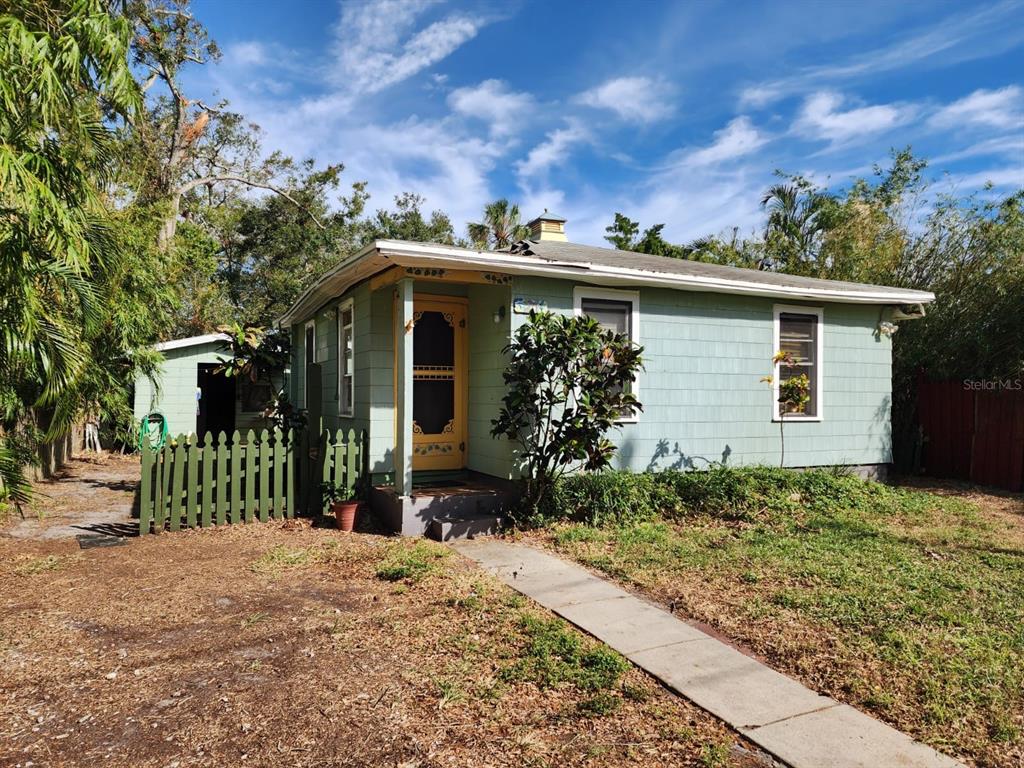 a view of house with backyard and garden