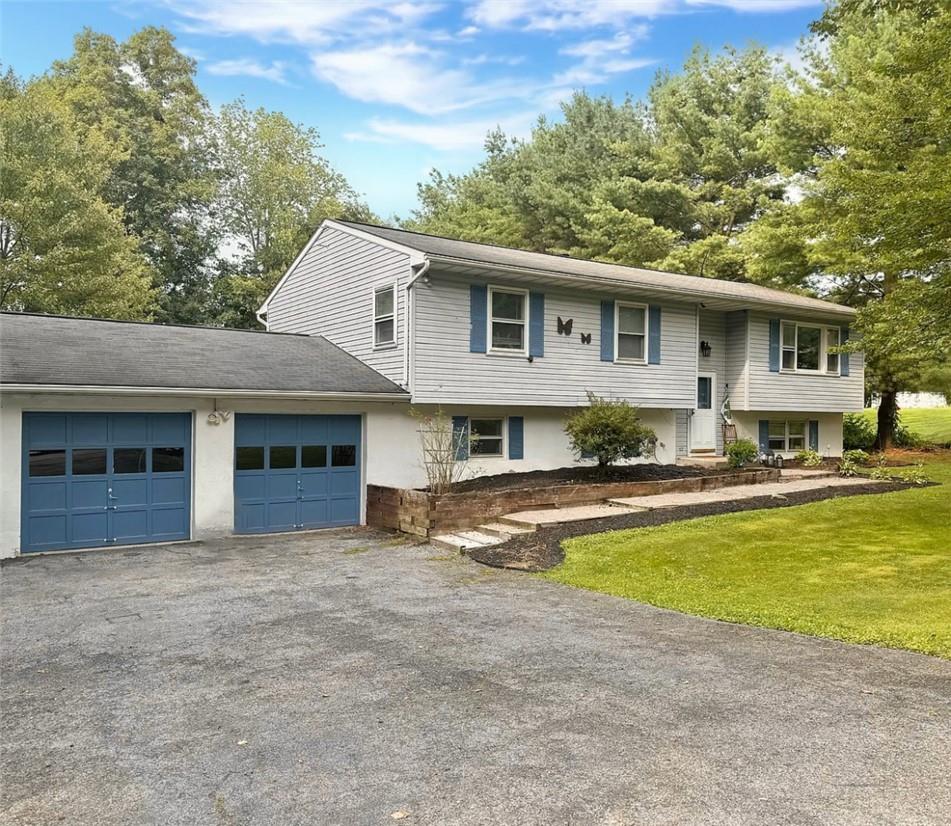 a front view of house with yard and outdoor seating