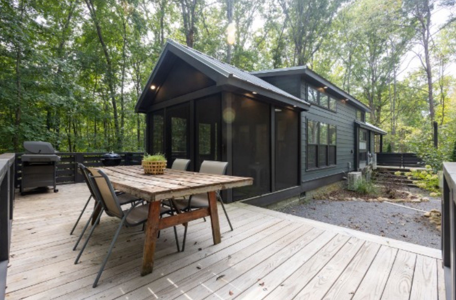 a backyard of a house with table and chairs