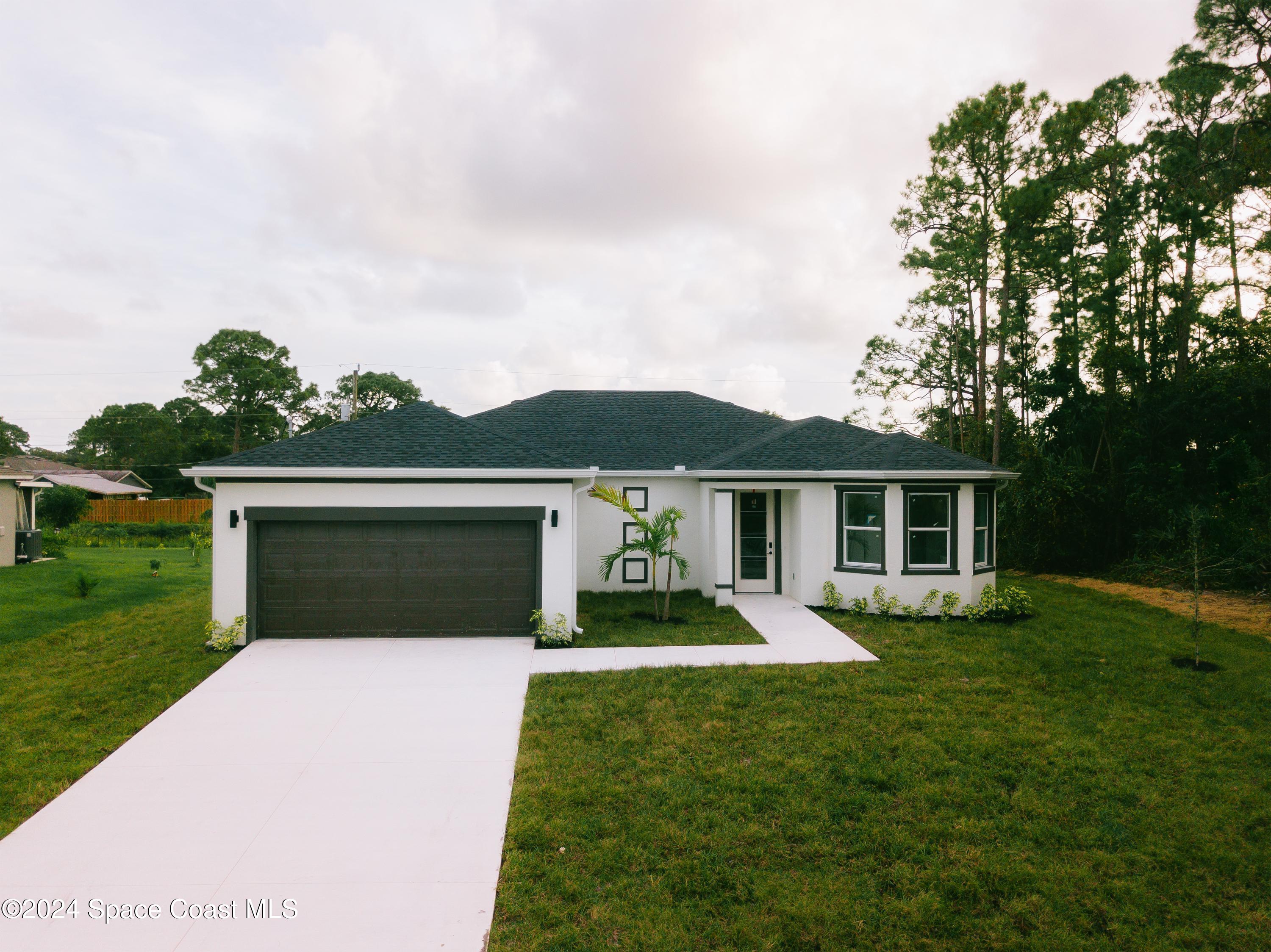 a front view of house with yard and green space