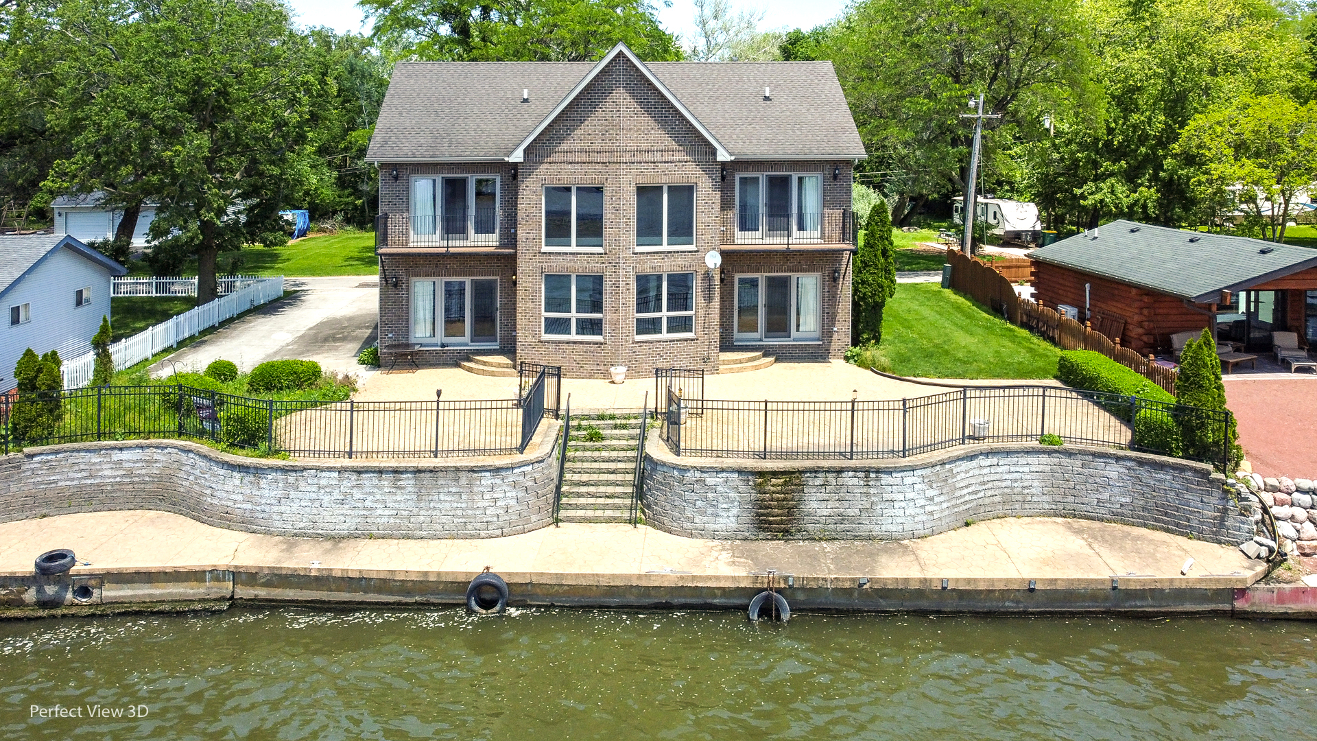 a aerial view of a house with a yard and swimming pool