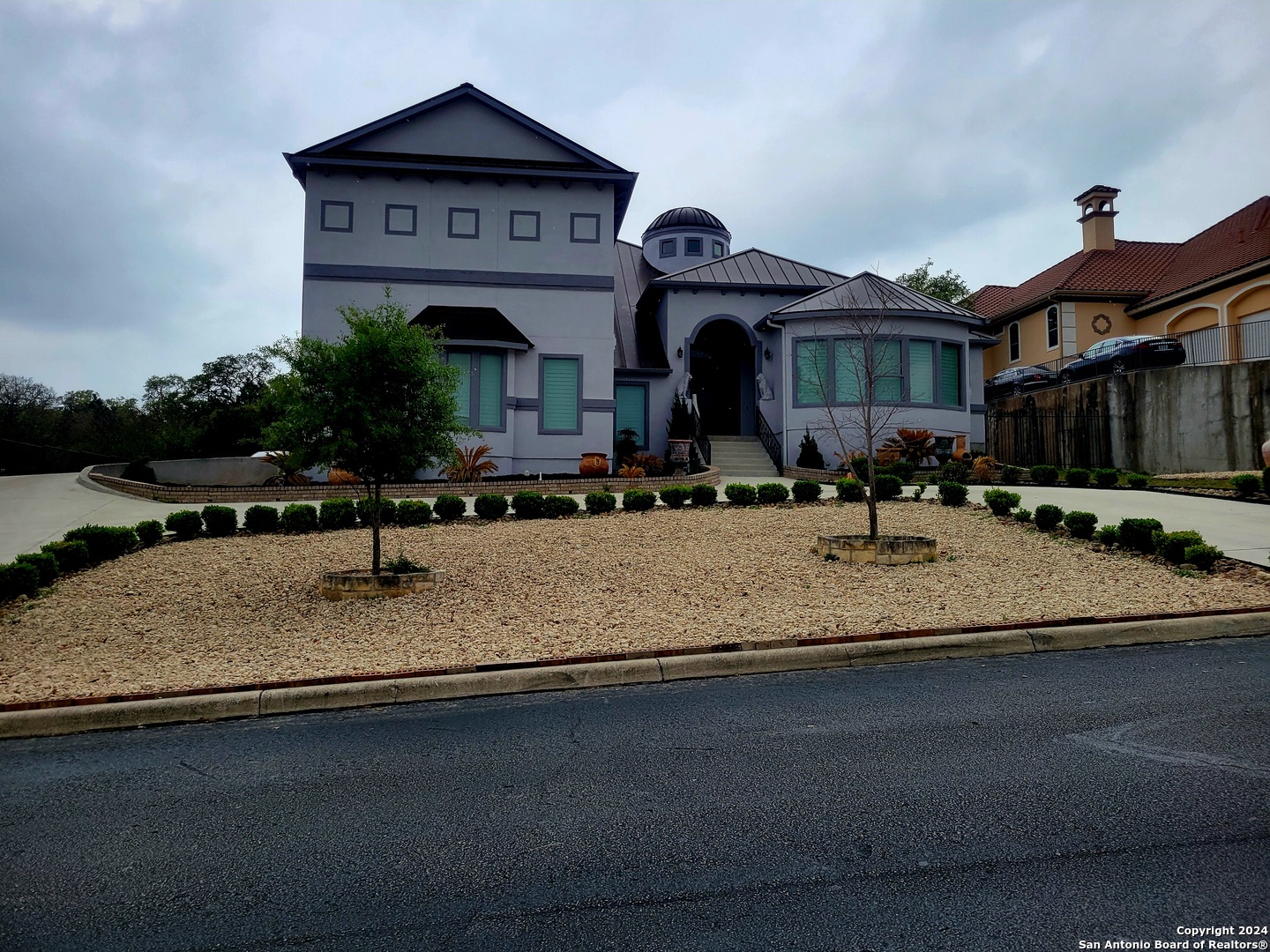 a front view of a building with garden