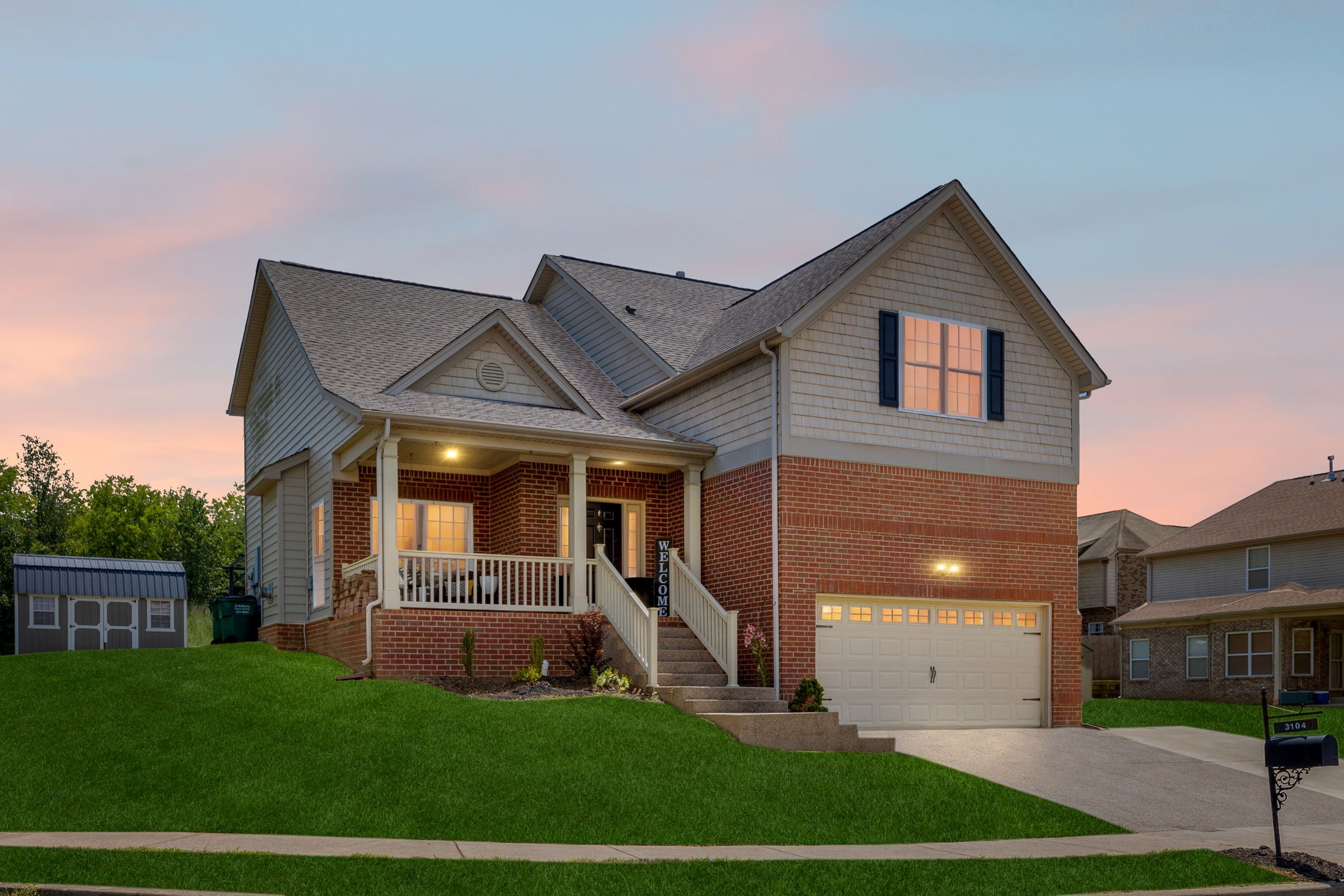 a front view of a house with a yard and garage