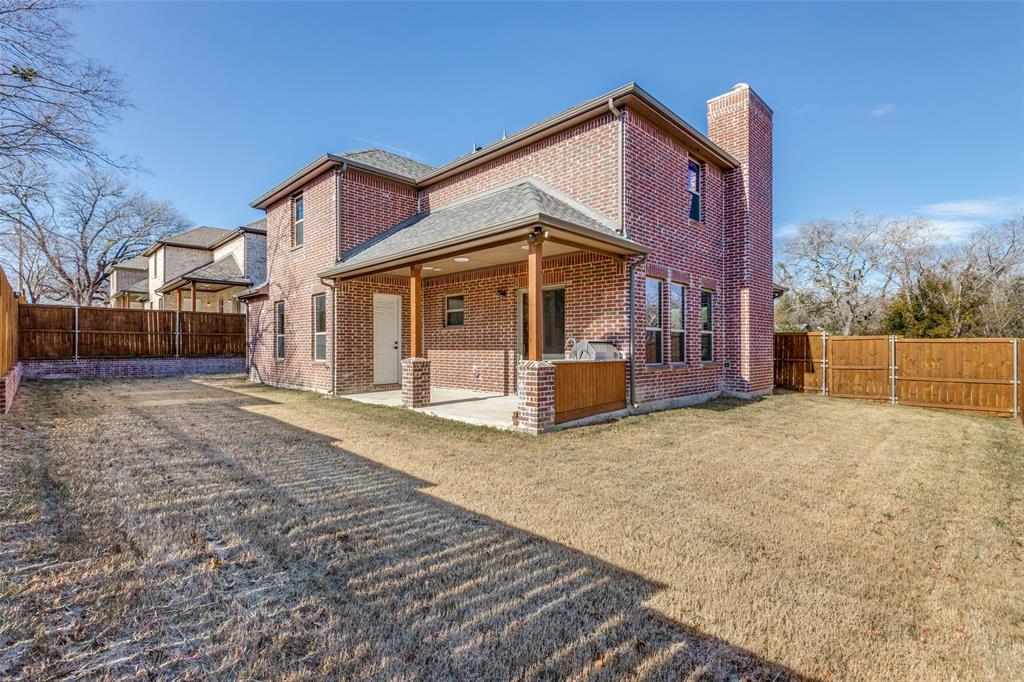 a front view of a house with a yard covered in snow