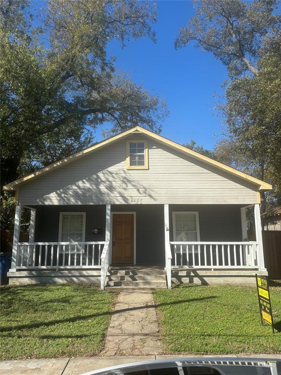 Bungalow-style home with a porch and a front lawn